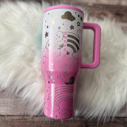 A pink and white tumbler mug with a handle, featuring a whimsical and playful design with stars, clouds, and other decorative elements.